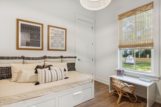 bedroom with wood-type flooring and multiple windows