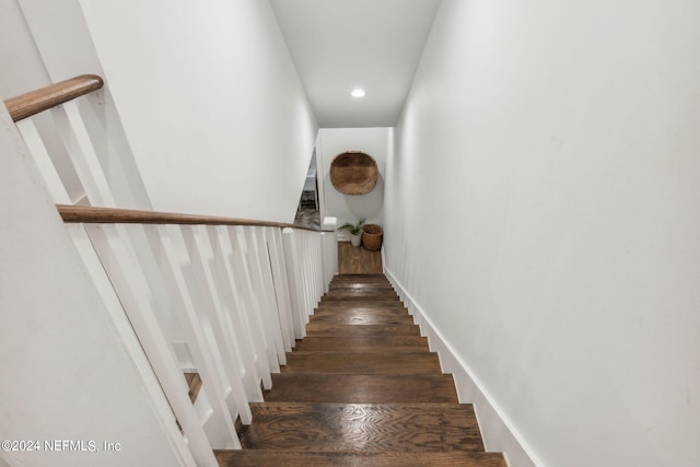 stairs featuring hardwood / wood-style flooring