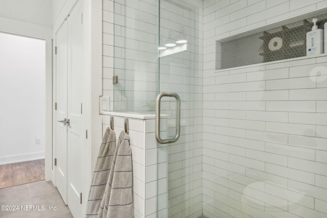 bathroom with tile patterned floors and an enclosed shower