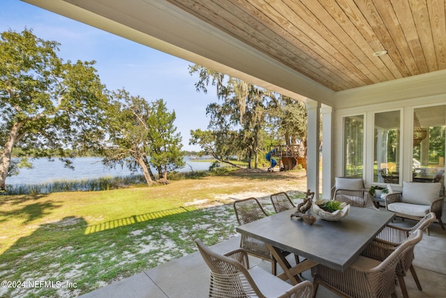 view of patio featuring a playground and a water view