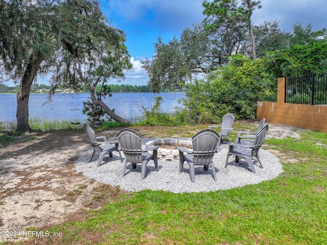 view of yard featuring a patio, an outdoor fire pit, and a water view