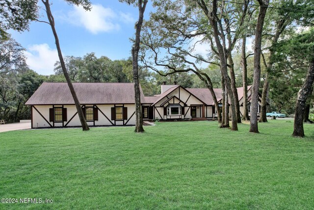 english style home with a front yard