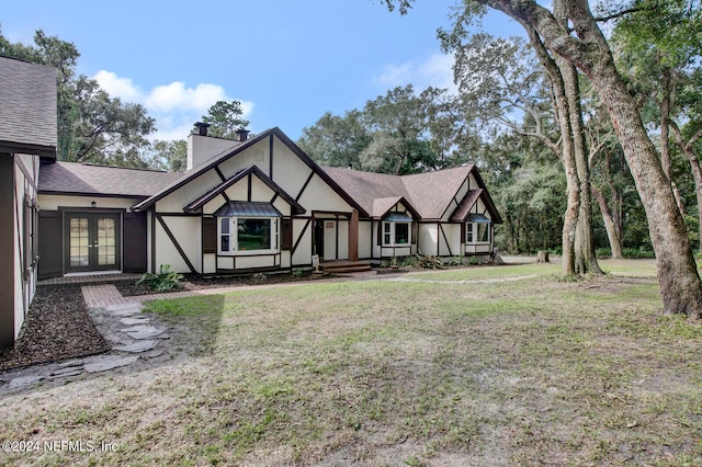 english style home with a front yard