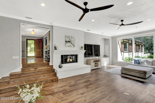 living room with hardwood / wood-style flooring, a healthy amount of sunlight, and ceiling fan