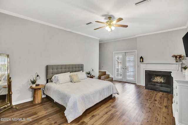 bedroom featuring ceiling fan, multiple windows, and hardwood / wood-style floors