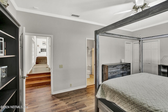 bedroom featuring ensuite bathroom, wood-type flooring, a closet, ceiling fan, and ornamental molding