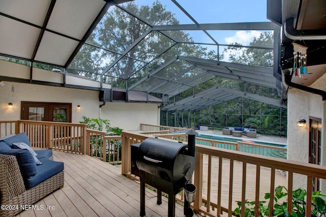 deck featuring area for grilling and glass enclosure