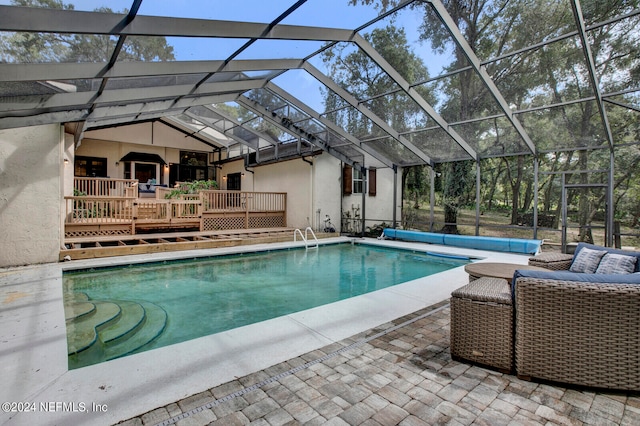 view of swimming pool featuring a patio area and a lanai