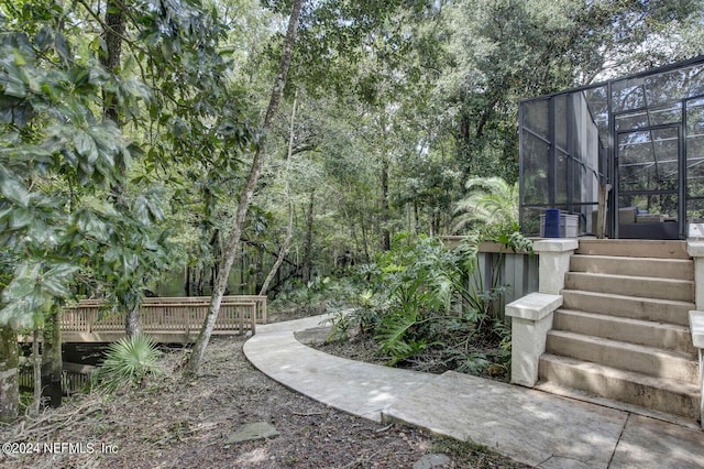 3565 Red Cloud Trl, Saint Augustine, FL 32086 - view of yard with a wooden deck and glass enclosure