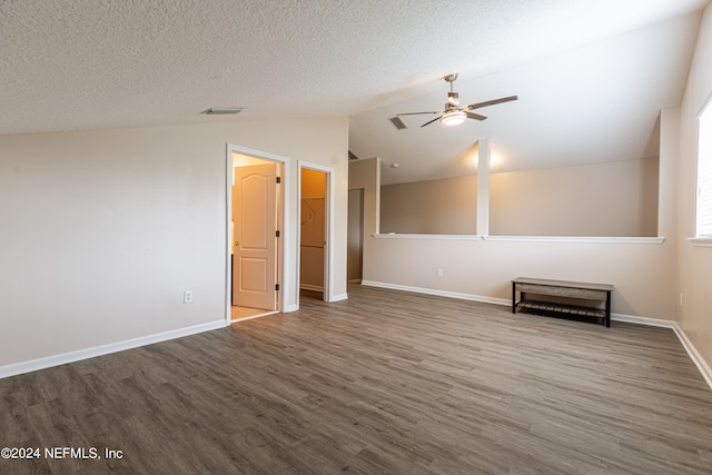 unfurnished room featuring ceiling fan, a textured ceiling, lofted ceiling, and hardwood / wood-style floors