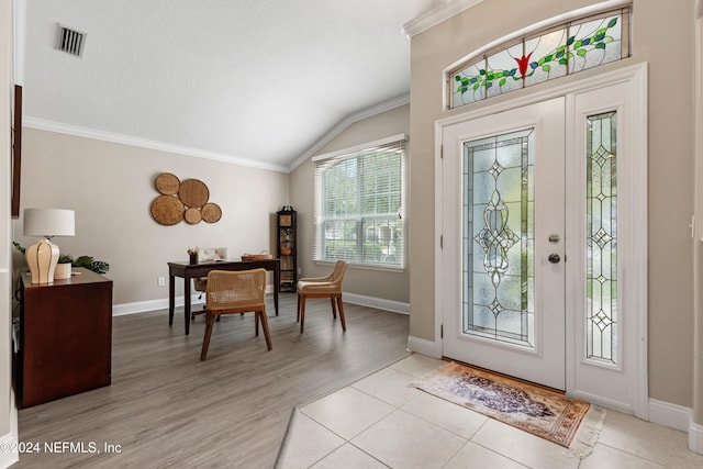 foyer entrance with lofted ceiling, light hardwood / wood-style flooring, and ornamental molding