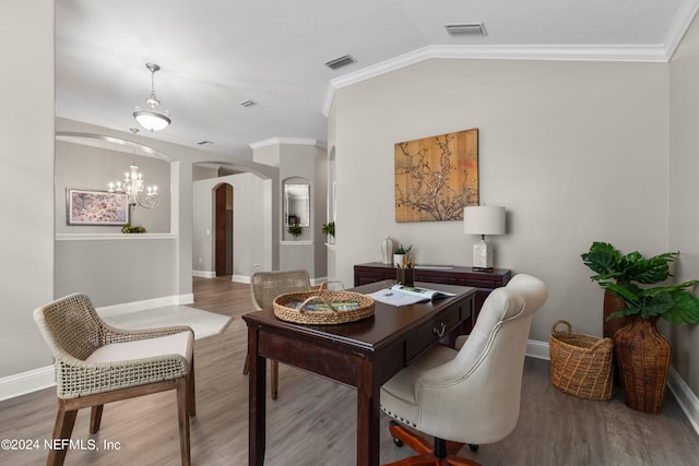 dining room with hardwood / wood-style flooring, ornamental molding, vaulted ceiling, and a chandelier