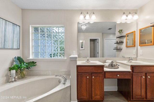 bathroom with vanity, a textured ceiling, wood-type flooring, and a tub