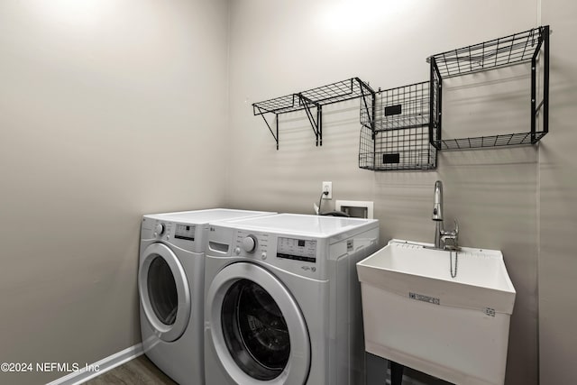 laundry room featuring dark wood-type flooring, sink, and separate washer and dryer