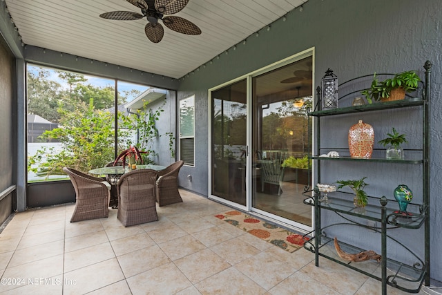 sunroom with ceiling fan and plenty of natural light