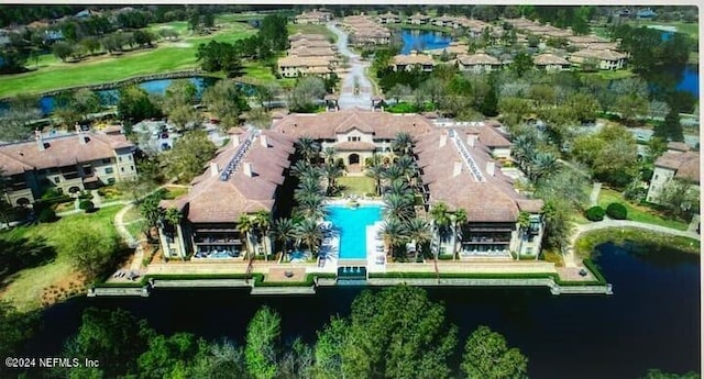 birds eye view of property with a water view