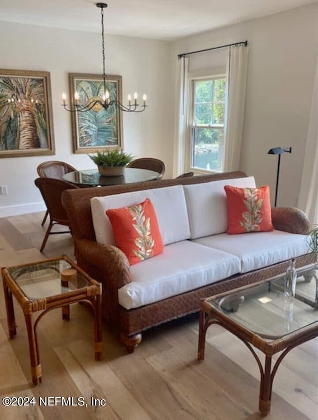 living room featuring an inviting chandelier and light hardwood / wood-style floors