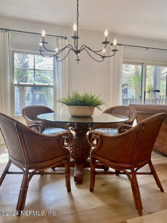 dining room featuring an inviting chandelier, light hardwood / wood-style flooring, and a wealth of natural light