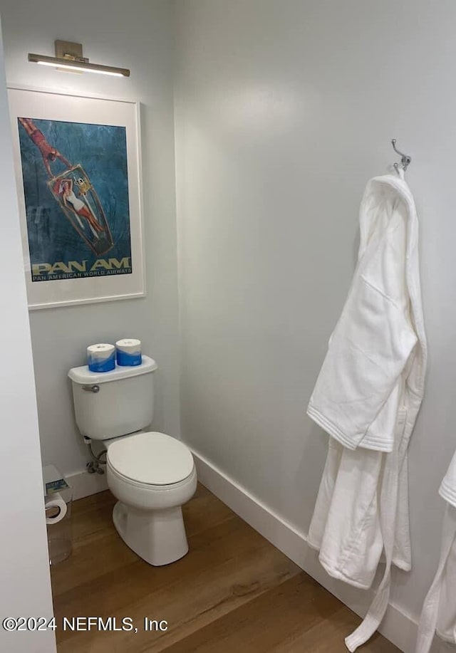 bathroom featuring wood-type flooring and toilet