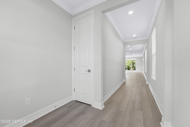 hall featuring light wood-type flooring and ornamental molding