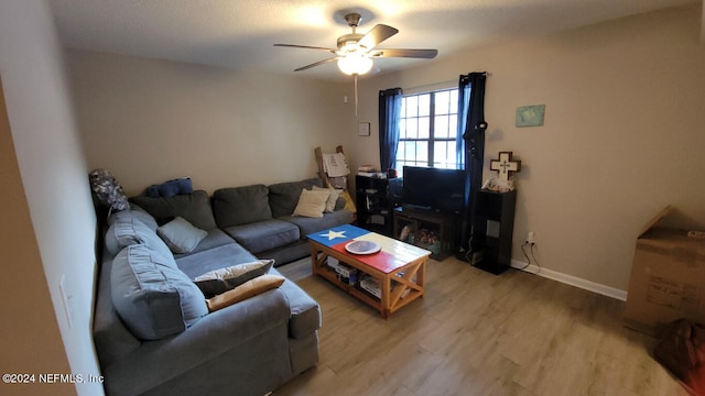 living room featuring light hardwood / wood-style floors and ceiling fan