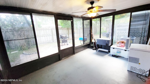 sunroom featuring ceiling fan and plenty of natural light