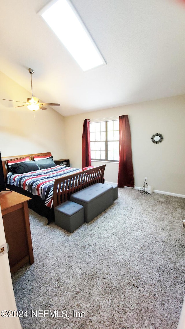 bedroom featuring carpet, ceiling fan, and a skylight