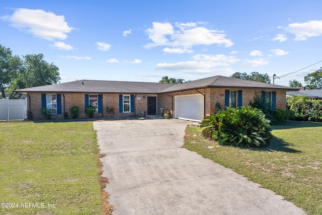 ranch-style home with a front lawn and a garage