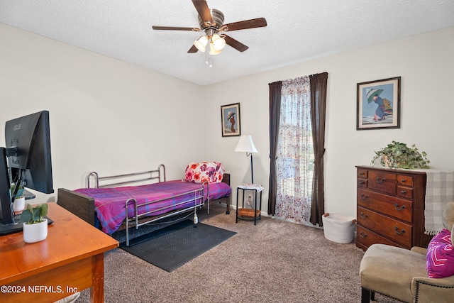 carpeted bedroom with ceiling fan and a textured ceiling