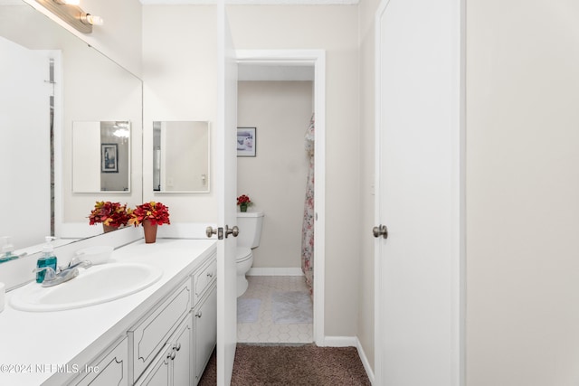 bathroom with vanity, toilet, and tile patterned floors