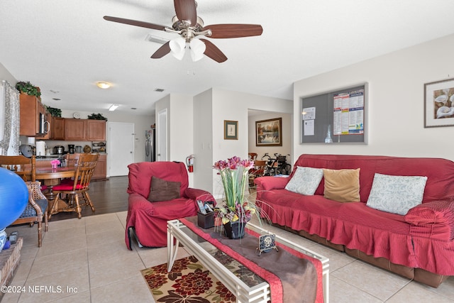 tiled living room featuring ceiling fan