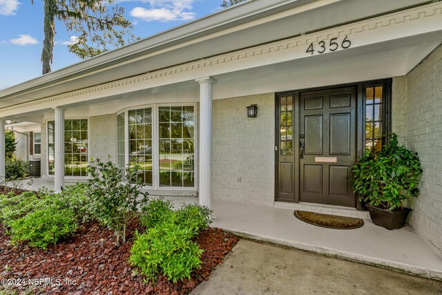 view of exterior entry with covered porch