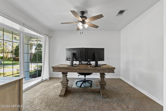 carpeted office space featuring ceiling fan