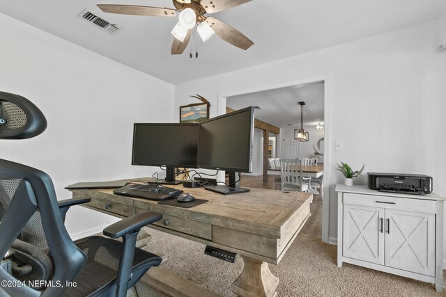 home office featuring ceiling fan and light carpet