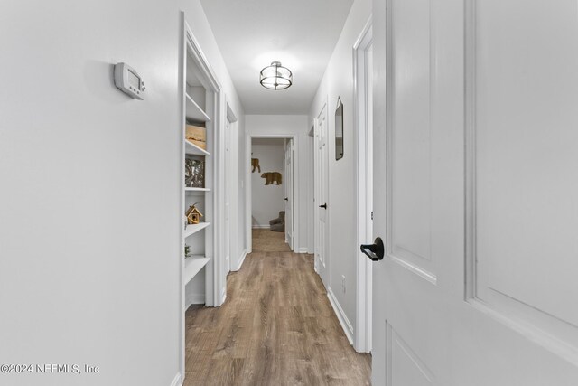 corridor with light hardwood / wood-style floors