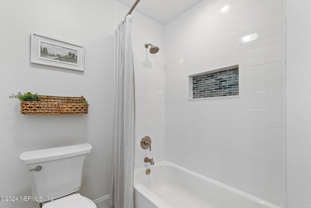 bathroom with toilet and shower / bath combo