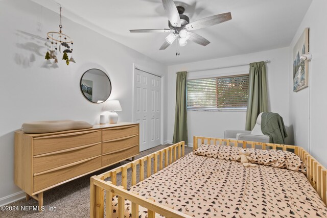 bedroom with carpet flooring, ceiling fan, and a closet