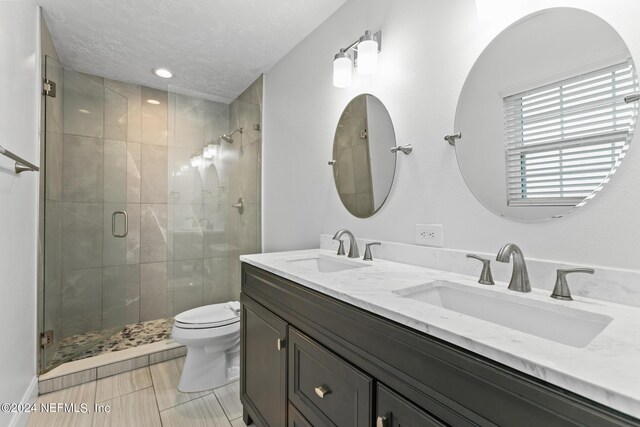 bathroom with vanity, toilet, and an enclosed shower