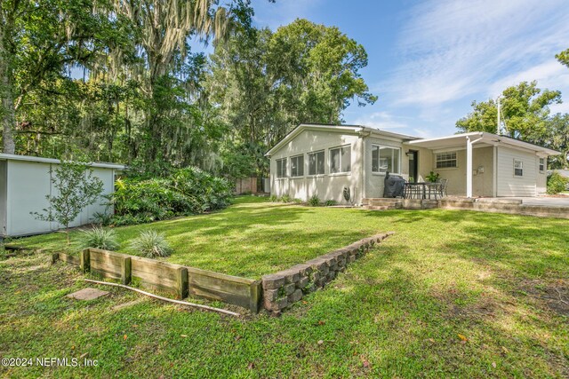 view of yard featuring a storage shed and a patio area