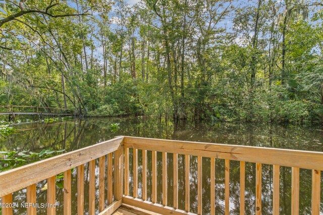 wooden terrace featuring a water view