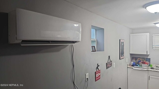 details with sink and a wall mounted air conditioner