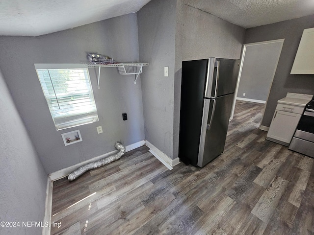 laundry room featuring washer hookup, a textured ceiling, dark hardwood / wood-style flooring, and hookup for an electric dryer