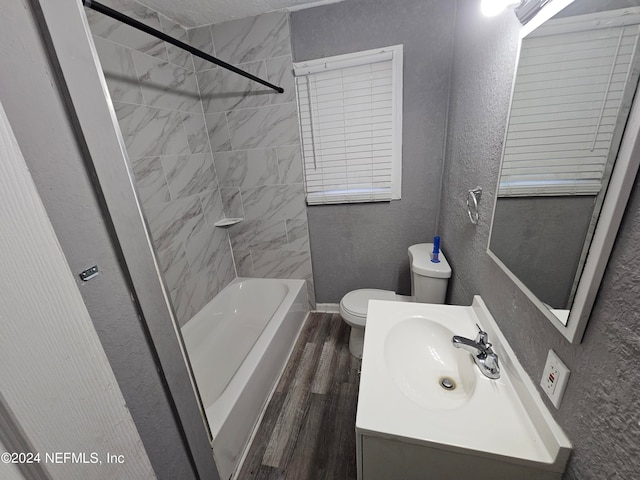 full bathroom featuring vanity, toilet, hardwood / wood-style floors, and tiled shower / bath combo