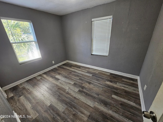 spare room featuring dark hardwood / wood-style floors