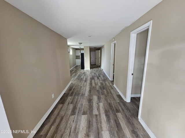 corridor with dark hardwood / wood-style floors