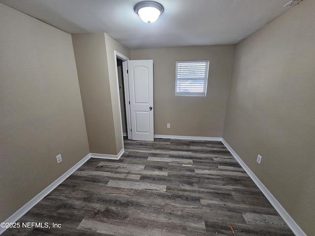 spare room with dark wood-type flooring