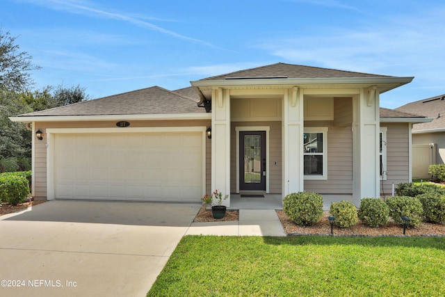 view of front facade with a garage and a front yard