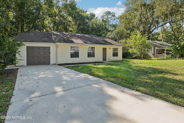 single story home with a front yard and a garage