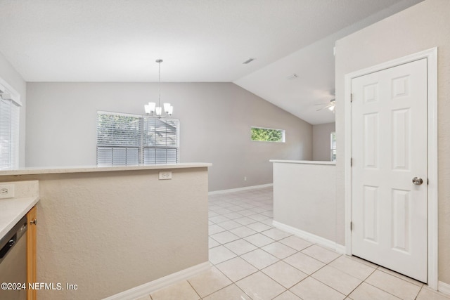 kitchen featuring hanging light fixtures, vaulted ceiling, dishwasher, light tile patterned flooring, and ceiling fan with notable chandelier