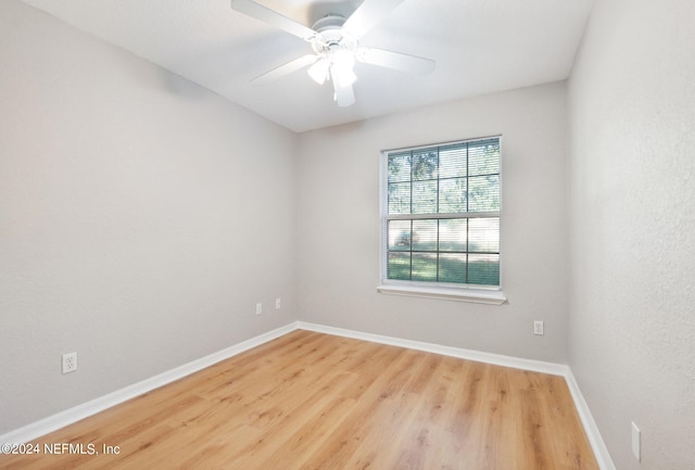 unfurnished room with hardwood / wood-style floors and ceiling fan